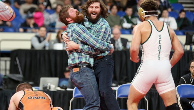 McKay wrestling coaches Troy Thomas (left) and his brother Tyler celebrate after David Rubio defeats Sprague's Landon Davis in the OSAA Wrestling State Championships Class 6A final for the 170-pound division at Memorial Coliseum in Portland on Saturday, Feb. 17, 2018.