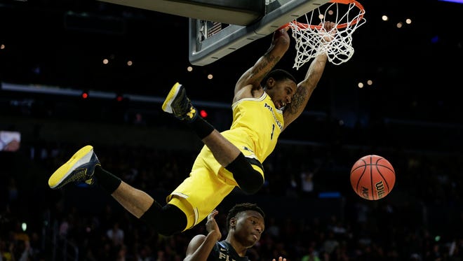 Michigan guard Charles Matthews (1) dunks against Florida State forward Mfiondu Kabengele (25) during first half of Elite Eight game in the NCAA tournament at Staples Center on Saturday, March 24, 2018.
