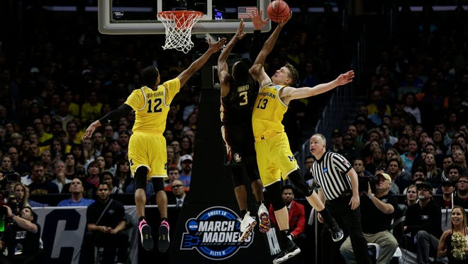 Michigan guard Muhammad-Ali Abdur-Rahkman (12)  and forward Moritz Wagner (13) tries to block a layup from Florida State guard Trent Forrest (3) during second half of the Elite Eight in the NCAA tournament at Staples Center on Saturday, March 24, 2018.