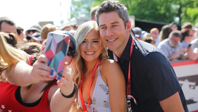 Arie Luyendyk Jr. and his fiancee Lauren Burnham, walk the red carpet during the 102nd running of the Indy 500 at Indianapolis Motor Speedway on Sunday, May 27, 2018.