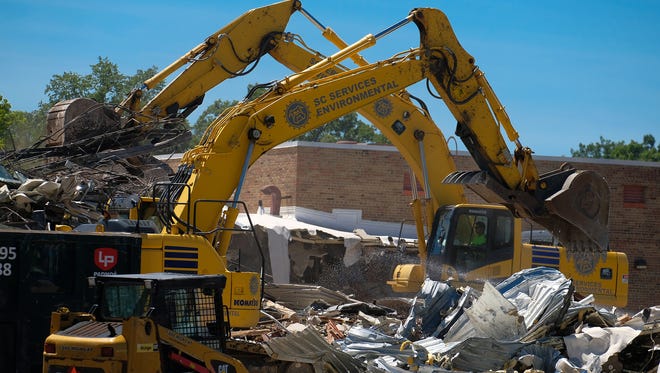 Heavy equipment is brought in to demolish Glencairn Elementary School in East Lansing Friday, July 6, 2018. 