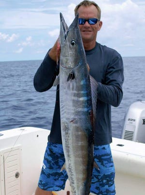 George Kessel, of Grant, poses with the 35.05-pound wahoo caught Saturday aboard his boat Shake Down. The fish earned $1,250 as the first-place wahoo in the Blue Water Open in Sebastian.