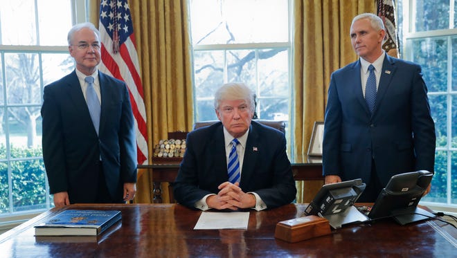 President Donald Trump, flanked by Health and Human Services Secretary Tom Price, left, and Vice President Mike Pence, right, is seen before addressing members of the media regarding the health care overhaul bill, Friday, March 24, 2017, in the Oval Office of the White House in Washington. (AP Photo/Pablo Martinez Monsivais)
