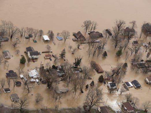 Homes in Utica, Ind. sit submerged in the floodwaters