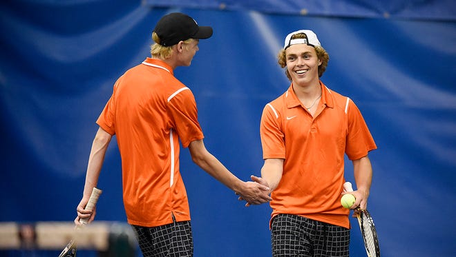 St. Cloud Tech's Nathan Jordre, left, and partner Nick Portz celebrate a point during the No. 1 doubles match against Bemidji in Section 8-2A tennis on Tuesday at Fitness Evolution in Sartell.