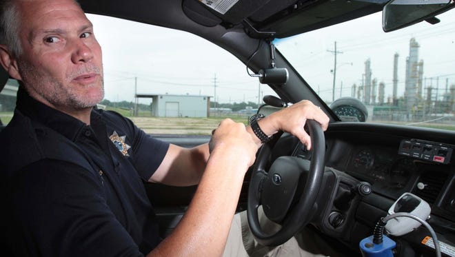Sterlington Police Chief Barry Bonner sits inside a patrol vehicle.