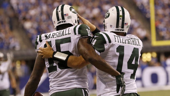 New York Jets wide receiver Brandon Marshall, left, is congratulated by quarterback Ryan Fitzpatrick after Marshall's second-half touchdown on Monday, Sept. 21, 2015, at Lucas Oil Stadium in Indianapolis.