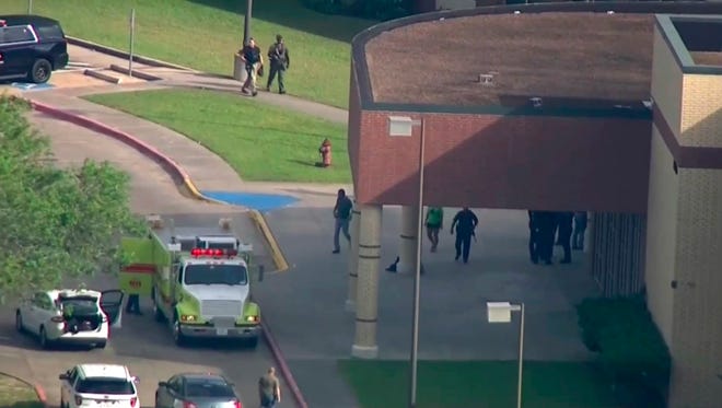In this image taken from video law enforcement officers respond to a high school near Houston after an active shooter was reported on campus, Friday, May 18, 2018, in Santa Fe, Texas. The Santa Fe school district issued an alert Friday morning saying Santa Fe High School has been placed on lockdown. (KTRK-TV ABC13 via AP)