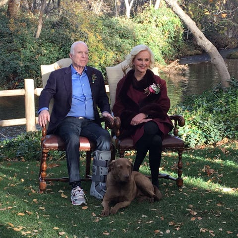 John and Cindy McCain pose with their dog, Burma,...