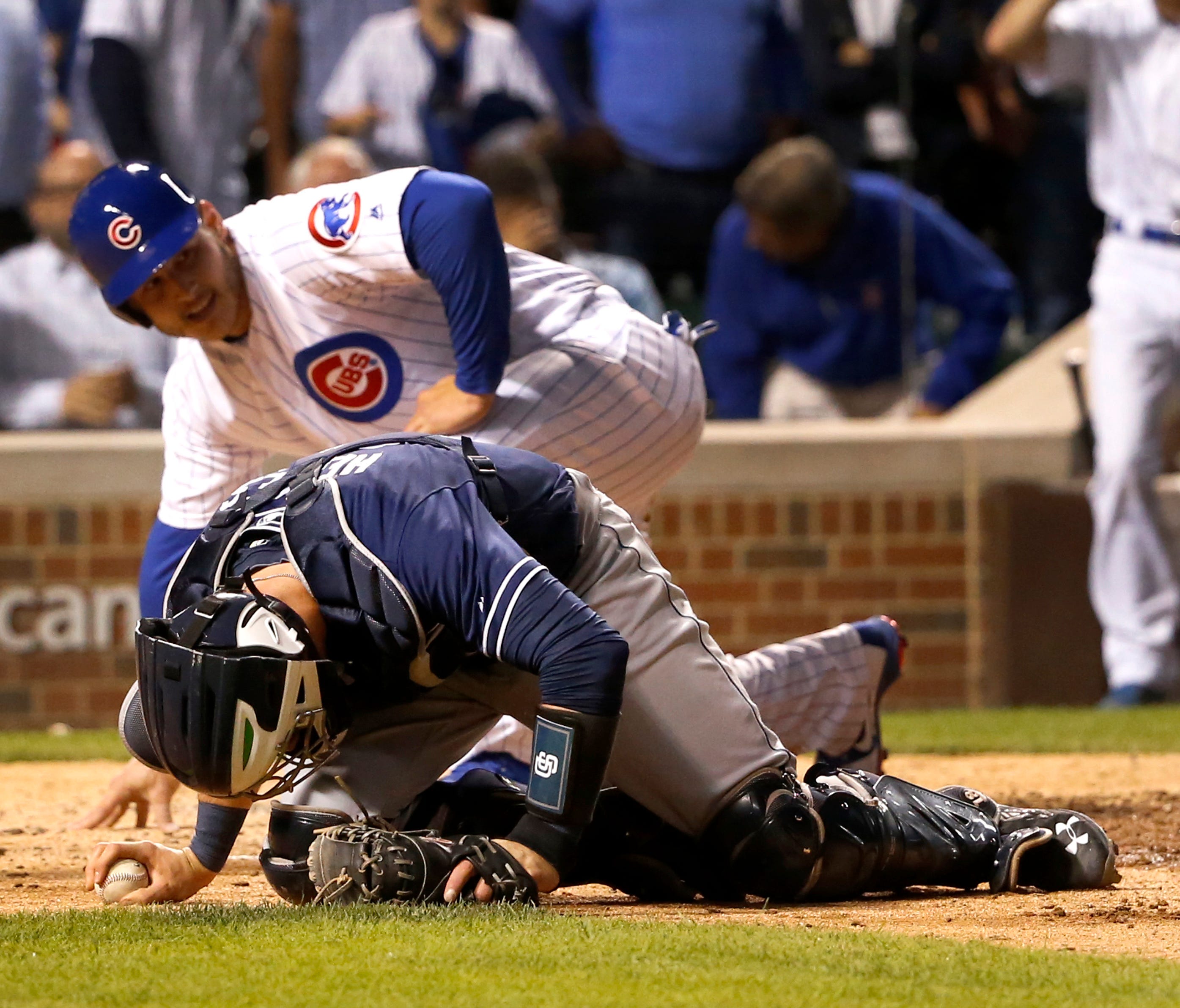 Padres catcher Austin Hedges was injured after tagging out the Cubs' Anthony Rizzo during a collision at home on Monday.