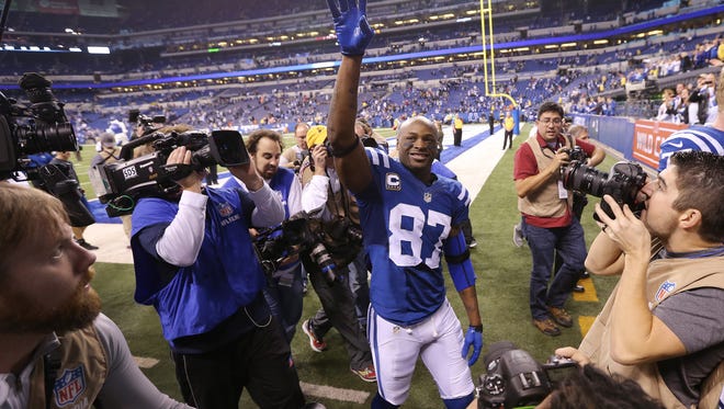 Indianapolis Colts wide receiver Reggie Wayne waves to fans as he leaves the field after the Colts win over the Bengals. Indianapolis hosted Cincinnati in the first round of the NFL Playoffs Sunday, January 4, 2015.