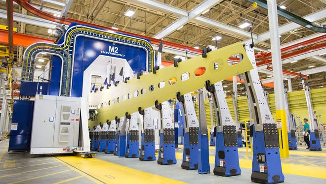 The wing skin panels for Boeing's first 737 MAX airplane are loaded into an automated assembly machine in the company's plant in Renton, Wash., on June 2, 2015.