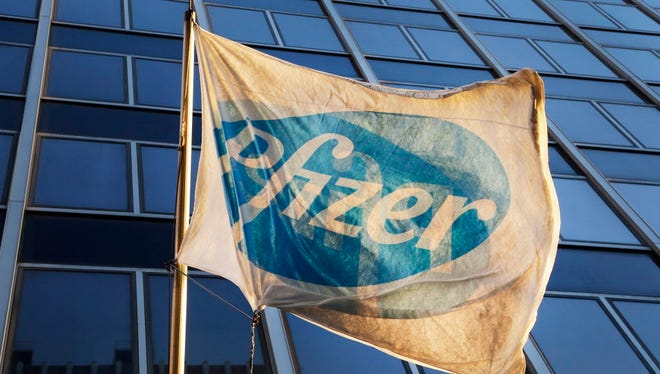 A Pfizer flag is displayed in front of world headquarters, Monday, Nov. 23, 2015 in New York.
