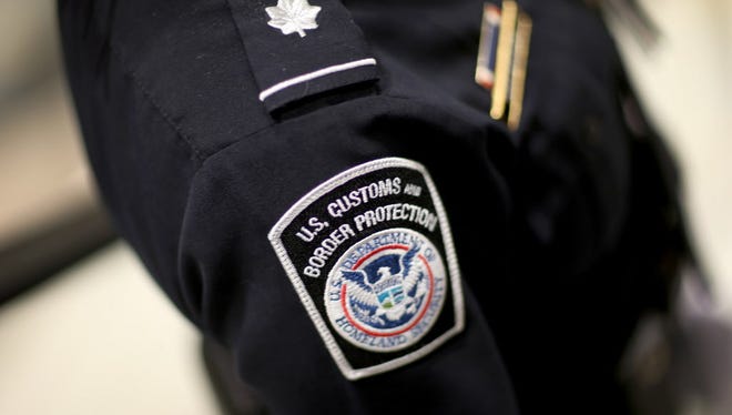 A U.S. Customs and Border Protection officer's patch is seen as they unveil a new mobile app for international travelers arriving at Miami International Airport on March 4, 2015.