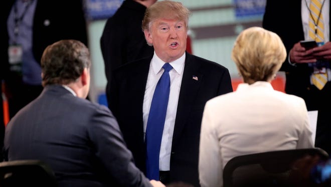 Donald Trump speaks with Fox News reporter Megyn Kelly after a Republican presidential candidate debate, March 3, 2016, in Detroit.