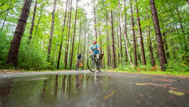 Bicyclists pedal along a trail in Northern Highland-American Legion State Forest.