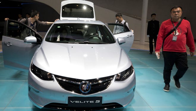 Visitors take a closer look at Buick's Velite 5, a rebranded Chevrolet Volt on display at the Auto Shanghai 2017 show at the National Exhibition and Convention Center in Shanghai, China, in April.