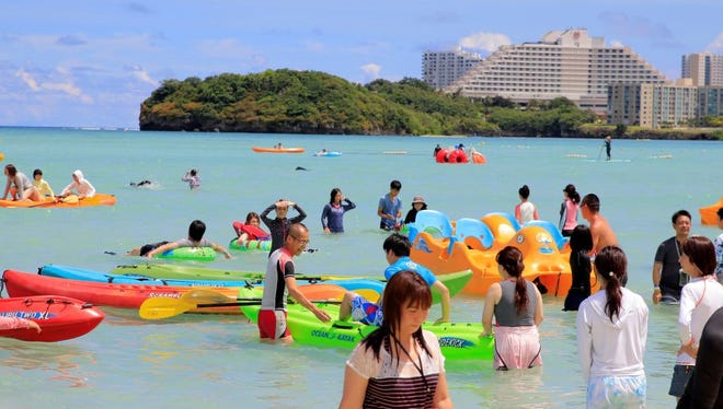 Tourists enjoy the activities along Tumon beach on the island of Guam on August 11, 2017.
Tourism-dependent Guam is looking to cash in on its new-found fame as a North Korean missile target, tapping an unlikely promotional opportunity to attract visitors to the idyllic island and prove that all publicity is good publicity. / AFP PHOTO / Virgilio VALENCIA        (Photo credit should read VIRGILIO VALENCIA/AFP/Getty Images)