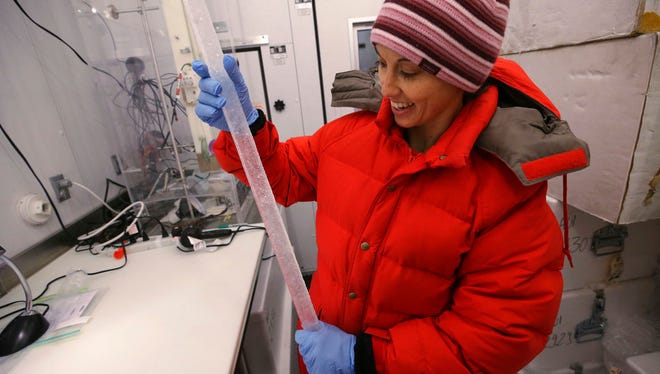 In this Feb. 21, 2018 photo, Dr. Monica Arienzo works on a 30,000 year old ice core in the ice lab at Desert Research Institute, in Reno. The rise and fall of the Roman Empire isn't just recorded in history books. Scientists from the Desert Research Institute  have pioneered a way to pinpoint pivotal moments in Western civilization using ancient lead pollution trapped deep inside the Greenland ice sheet.