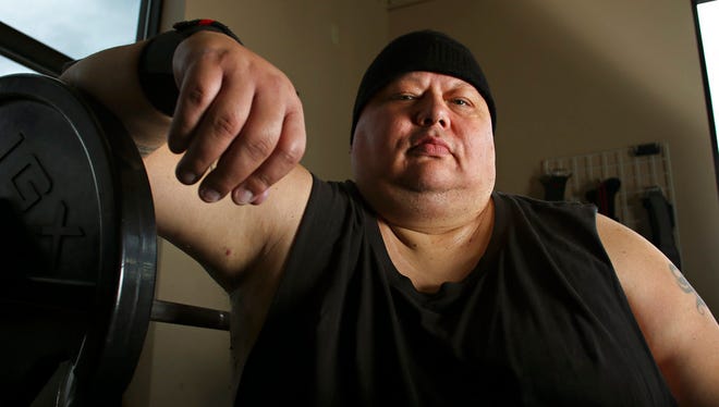 In this June 14, 2018 photo, power lifter Sylvester Vermillion poses at the Wave Aquatic and Fitness Center in Whitefish, Mont. At the 2018 Montana Special Olympics State Games, Vermillion squatted 405 pounds. He also bench-pressed 230 and deadlifted 430, winning each individual event and, with a collective 1,065 pounds, the combined powerlifting title as well.  (Justin Franz/Flathead Beacon via AP)