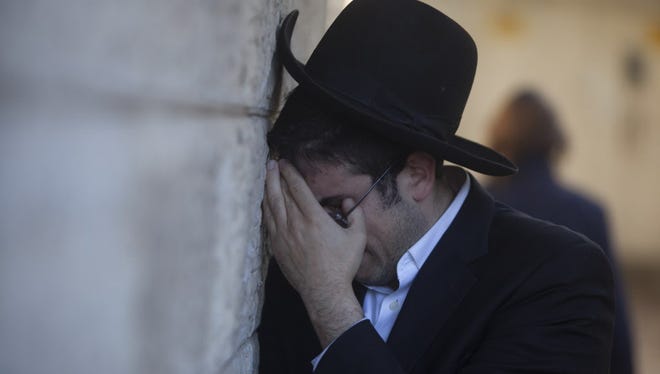 An Ultra Orthodox Jewish man cries during the funeral of Rabbi Moshe Twersky on Nov. 18, 2014, in Jerusalem. Twersky was killed along with Rabbi Aryeh Kupinsky, who spent his childhood in a Detroit suburb.