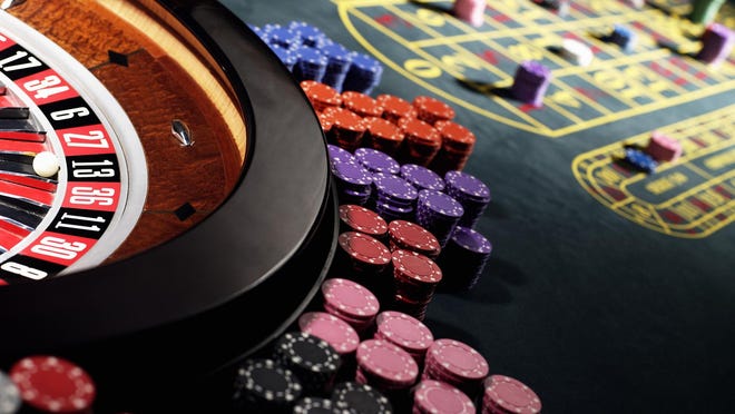 File art of gambling chips around a roulette wheel.