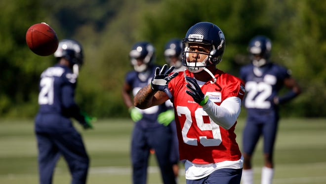Seattle Seahawks' Earl Thomas reaches for a ball at NFL football training camp, Wednesday, Aug. 19, 2015, in Renton, Wash.