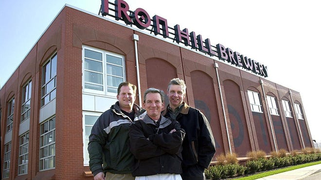 Iron Hill Brewery and Restuarant partners, Mark Edelson (L), Kevin Davies (C) and Kevin Finn (R) stand outside of the Iron Hill Brewery & Restaurant. They now own 12 locations. The restaurant chain celebrates 20 years in business.