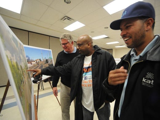 Greg Mackay, Rick Staples, and Maurice Clark, from left, look over renderings following a public meeting to review design details for streetscape improvements to Magnolia Ave. on Thursday, Jan. 21, 2016. (ADAM LAU/NEWS SENTINEL)