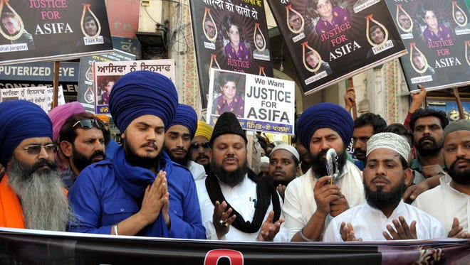Members of Sikh and Muslim organizations take part in a prayer for victim of rape crime during a march and protest in Amritsar, India, on April 21, 2018.