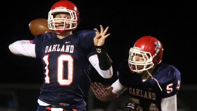 Oakland's quarterback Brendan Matthews (10) drops back to pass the ball as his teammate Jacob Frazier (54) guards Matthews during the game against Riverdale at Oakland, on Friday Oct. 16, 2015.