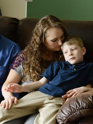 Maverick Ramseyer, who has cerebral palsy due to brain damage at birth, sits with his mother, Elizabeth, at their Stayton home on March 17, 2014. His parents allege in a lawsuit that medical malpractice and negligence at Silverton Hospital caused injury to Maverick's brain. Jury selection has begun today.