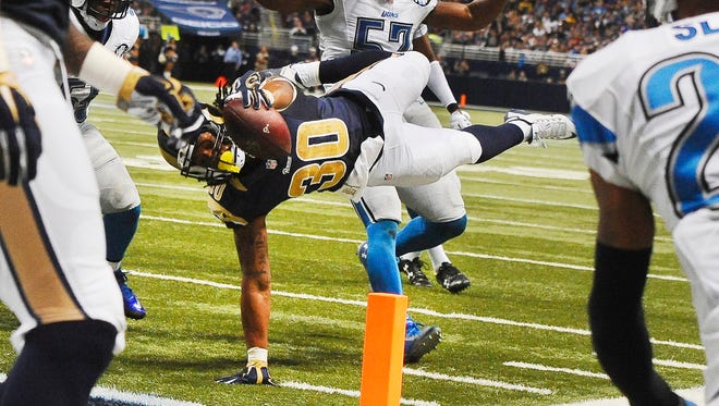 Todd Gurley dives for the pylon in front of the Lions' Josh Bynes for a touchdown in the third quarter.