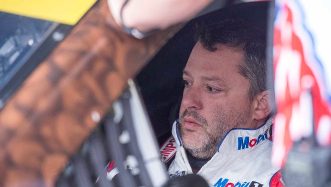 Tony Stewart sits in his car at Dover International Speedway.