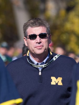 Michigan athletic director Dave Brandon walks to Spartan Stadium on Oct. 25, 2014 in East Lansing.