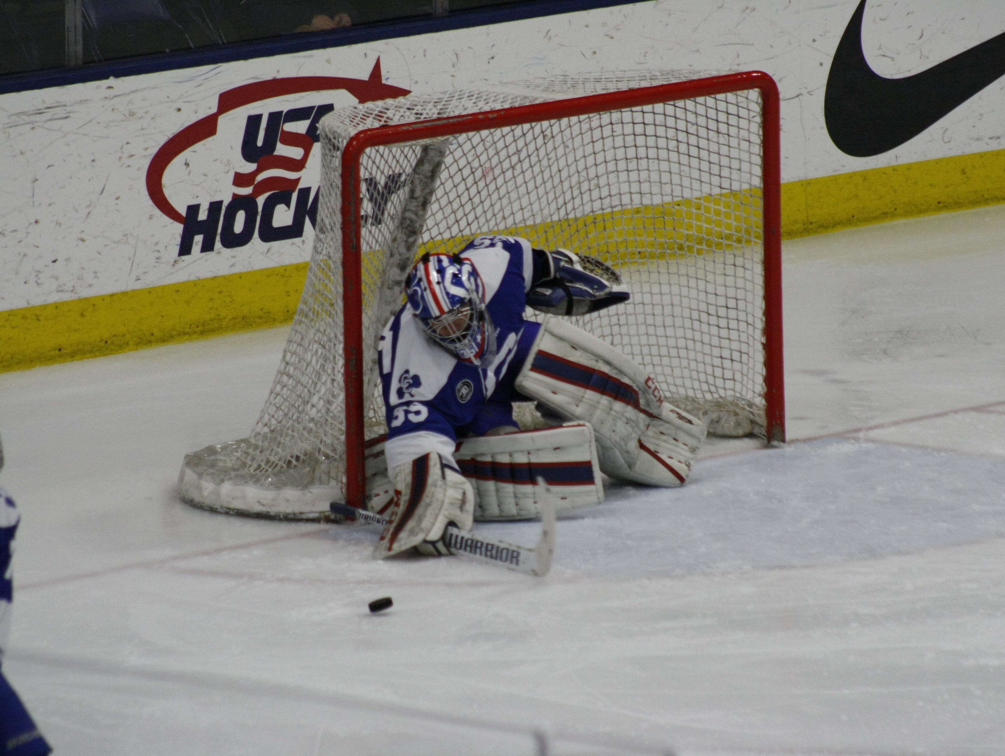 Novi Detroit Catholic Central goalie Sean Finstrom knocks away a Grandville shot during Friday's Division 1 state semifinal match at USA Hockey Arena in Plymouth.