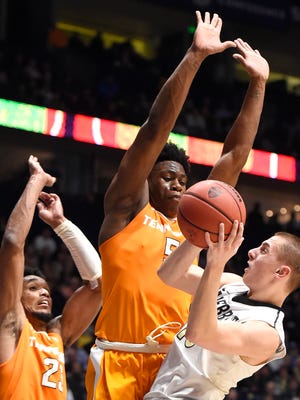 Vanderbilt guard Riley LaChance (13) runs into Tennessee forward Admiral Schofield (5) and Tennessee forward Derek Reese (23) during the first half of their game in the SEC Men's Basketball Tournament at Bridgestone Arena Thursday March 10, 2016, in Nashville, Tenn.