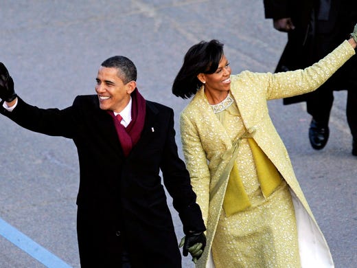 President Obama and Michelle walk past the reviewing