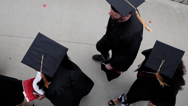 Ohio State graduates filed into the stands at Ohio Stadium during spring commencement on May 5, 2019. The average Ohioan owes nearly $35,000 in student loans.