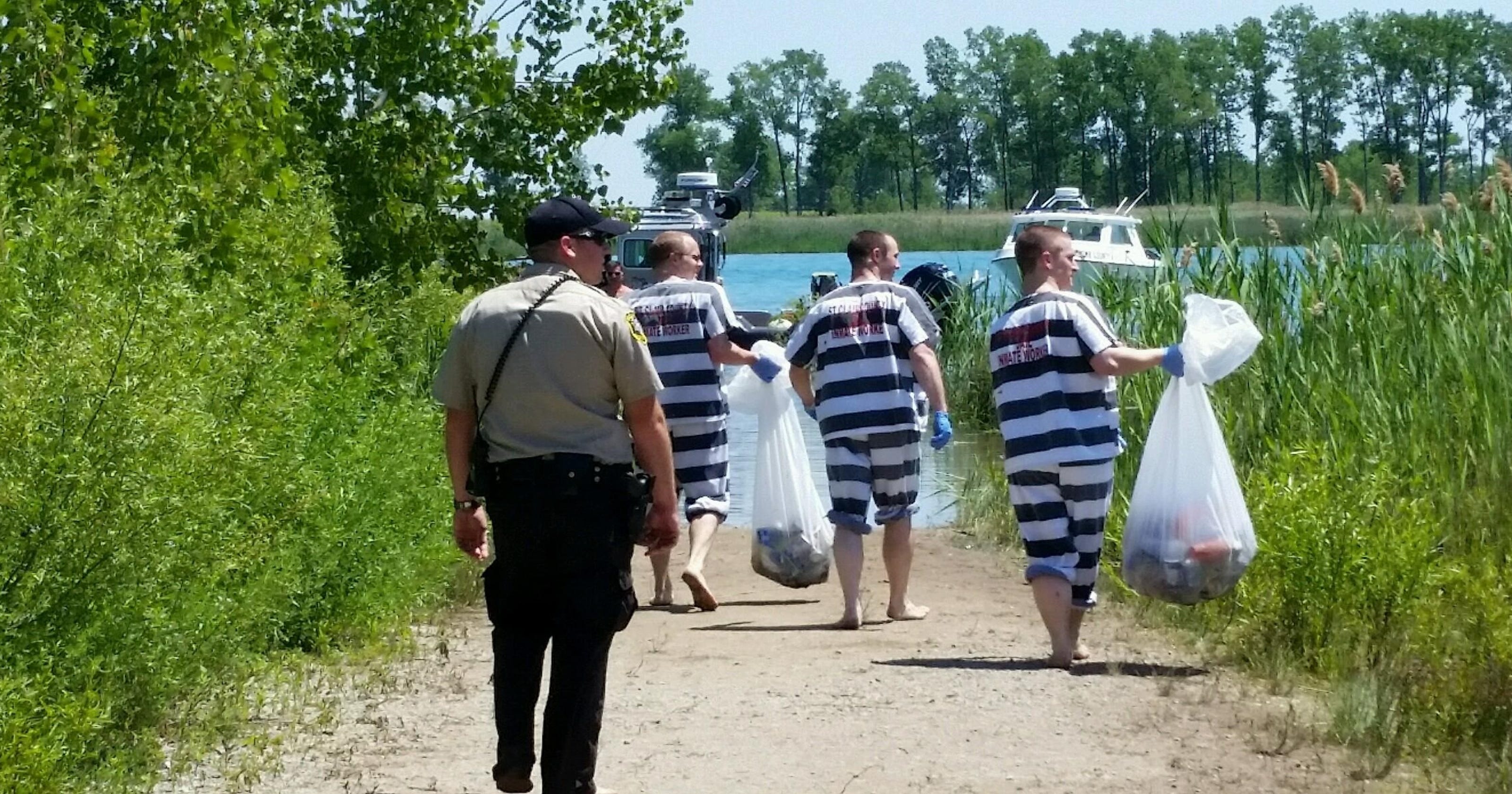 Inmates pick up trash on Gull Island