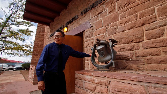 Seymour Smith rings a bell on Monday to start the fall session of the Navajo Nation Council at the Council Chambers in Window Rock, Ariz.