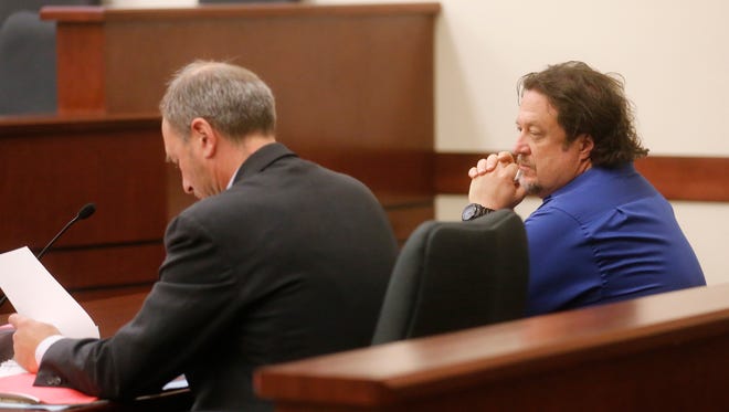 Plaintiff Patrick Cheney, right, sits with his lawyer Chris Hatfield Thursday in Aztec District Court.