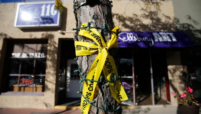 Yellow ribbons in support of the military are tied onto a tree Thursday on Main Street in Farmington.