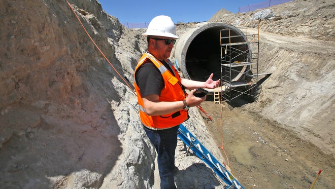 Jeremy Simpson, a safety manager at Navajo Agricultural Products Industry, talks on May 25 about repairs on a siphon that delivers water to NAPI farmlands south of Farmington.