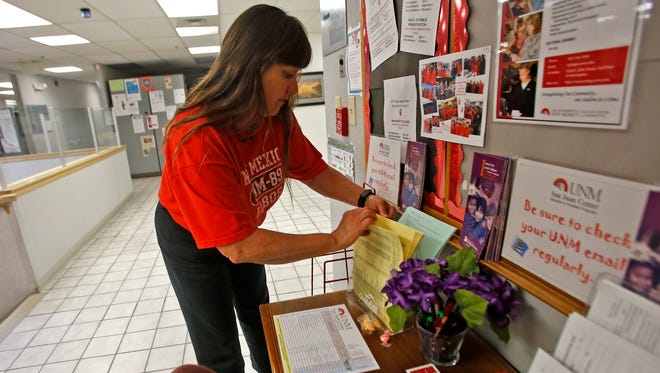 Catherine Walker Grobler, a student recruitment specialist for the University of New Mexico, works in her office on Tuesday at the UNM San Juan Center in Farmington.