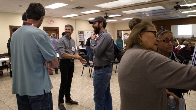 At center, Craig Townsend, a natural resource specialist with the Bureau of Land Management, talks with colleagues on Nov. 10 during a scoping meeting at the Huerfano Chapter house.