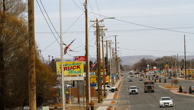The north side of U.S. Highway 64 in Bloomfield is lined with utility poles and power lines. City officials in Bloomfield are trying to acquire local electrical assets as part of an attempt to start their own electric utility.