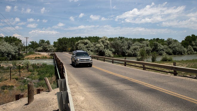 A vehicle crosses over the San Juan River  June 11 on County Road 5500 southwest of Bloomfield.