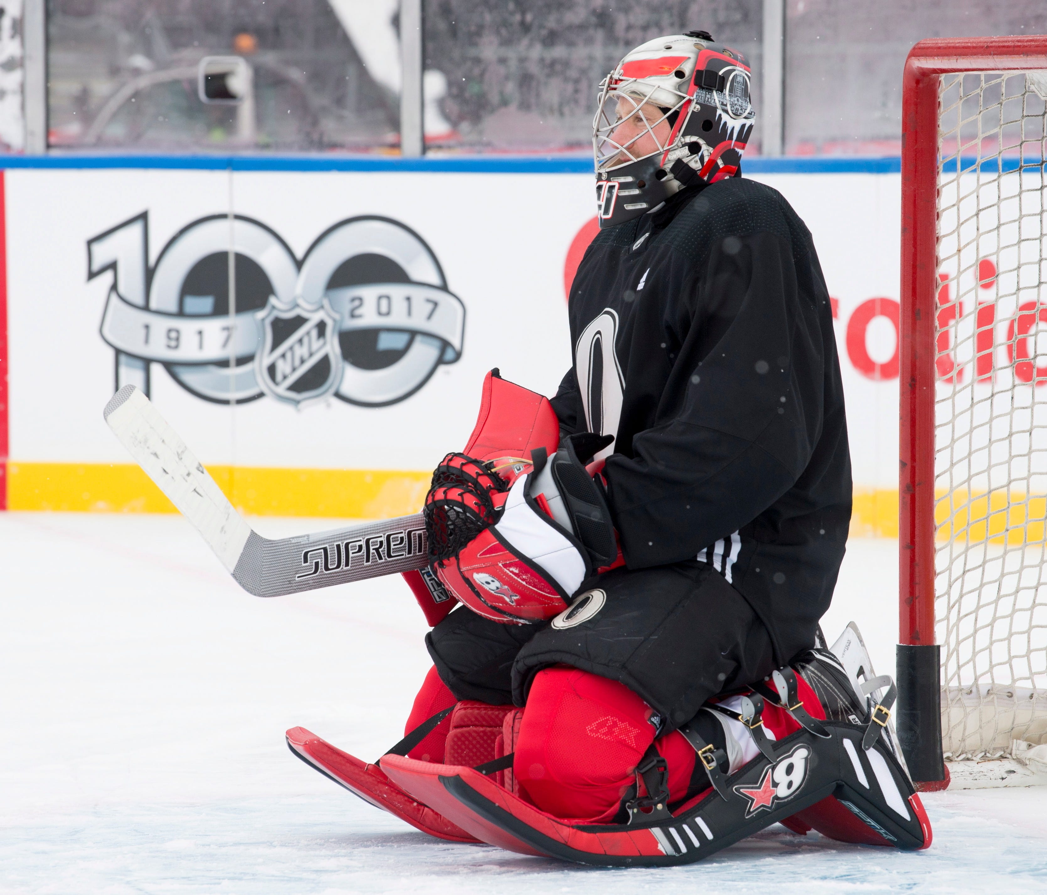 Ottawa Senators goalie Craig Anderson kneels in his crease as he watches drills during an outdoor practice Friday Dec. 15, 2017, in Ottawa. The Senators will play the Montreal Canadiens in the NHL 100 Classic on Saturday.