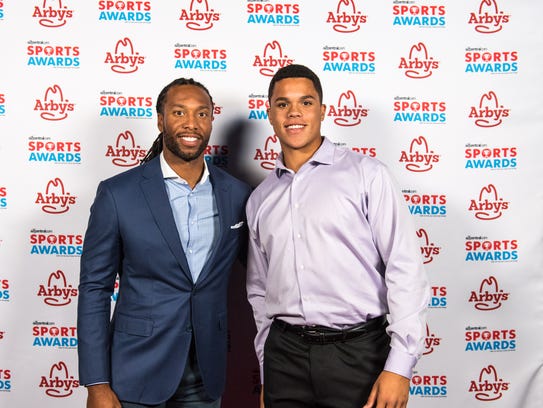 Larry Fitzgerald poses for a photo with Turner Washington